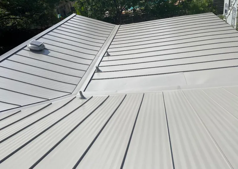 Solar attic fan installed on a metal roof for Roof Ventilation in Maitland
